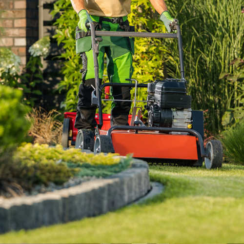 Landscaper pushing a lawn mower